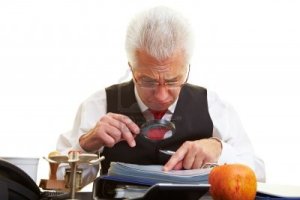 6357963-senior-citizen-reading-the-fine-print-in-a-contract[1]